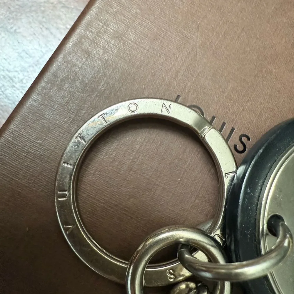 Used in great condition Louis Vuitton Silver and Black Keychain minor scratches